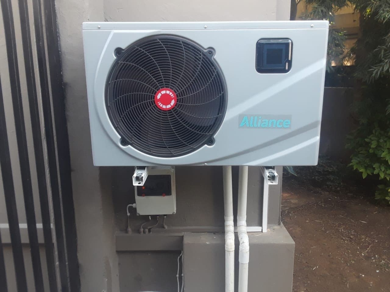 Pool heat pump mounted on a wall